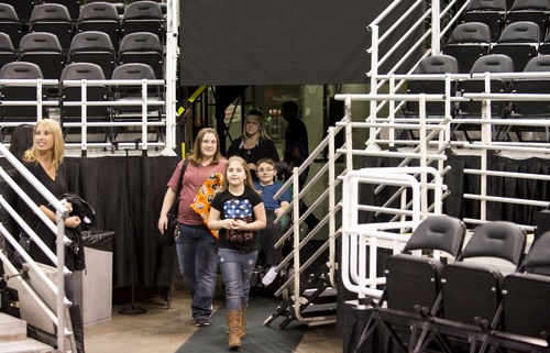 Lennie Mahler  |  The Salt Lake Tribune
Austin Bennett, a 12-year-old with Duchenne muscular dystrophy, enters the court at EnergySolutions Arena with his mom, Karalee, and sister, April, to be surprised by Harlem Globetrotters player Buckets Blakes, Friday, Feb. 7, 2014. Bennett will meet and watch the Harlem Globetrotters team play the World All-Stars on Monday, Feb. 10, as a "bucket list" item fulfilled by the Children and the Earth charity.