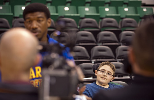 Lennie Mahler  |  The Salt Lake Tribune
Austin Bennett, a 12-year-old with Duchenne muscular dystrophy, watches Harlem Globetrotters player Buckets Blakes speak with TV crews upon meeting him Friday, Feb. 7, 2014, at EnergySolutions Arena. Bennett will meet and watch the Harlem Globetrotters play the World All-Stars on Monday, Feb. 10, as a "bucket list" item fulfilled by the Children and the Earth charity.