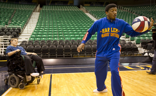 Lennie Mahler  |  The Salt Lake Tribune
Austin Bennett, a 12-year-old with Duchenne muscular dystrophy, watches Harlem Globetrotters player Buckets Blakes perform tricks with the basketball upon meeting him Friday, Feb. 7, 2014, at EnergySolutions Arena. Bennett will meet and watch the Harlem Globetrotters play the World All-Stars on Monday, Feb. 10, as a "bucket list" item fulfilled by the Children and the Earth charity.