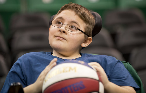 Lennie Mahler  |  The Salt Lake Tribune
Austin Bennett, a 12-year-old with Duchenne muscular dystrophy, holds a Harlem Globetrotters ball Friday, Feb. 7, 2014, at EnergySolutions Arena. Bennett will meet and watch the Harlem Globetrotters play the World All-Stars on Monday, Feb. 10, as a "bucket list" item fulfilled by the Children and the Earth charity.