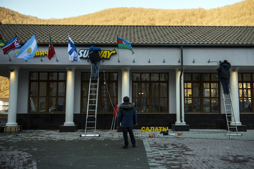 Chris Detrick |  The Salt Lake Tribune

Workers hang flags at the Gorky Gorod hotel complex in the Mountain Cluster in Krasnaya Polyana, Russia, before the start of the 2014 Sochi Olympics Wednesday February 5, 2014