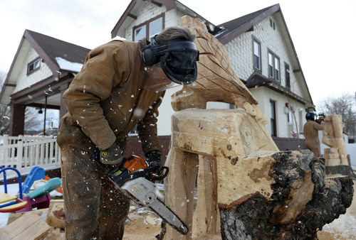 Francisco Kjolseth  |  The Salt Lake Tribune
Wayne Sharp, left, and his son Tyler carve up a pair of stumps into a sculpture with their chainsaws to help cheer up the kids at Family Crisis Recovery Center in Midvale on Friday, Feb. 7, 2014.