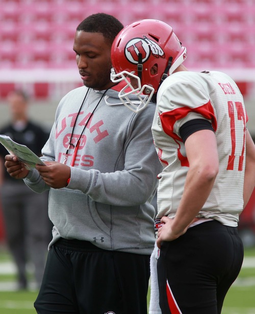 Leah Hogsten  |  The Salt Lake Tribune
University of Utah football team's Brian Johnson runs through plays with  quarterback Logan Bateman during the Utes practice, Tuesday, March 26, 2013. Johnson has been demoted from offensive coordinator, but still coaches the quarterbacks as the "co-coordinator" with the newly hired Dennis Erickson.