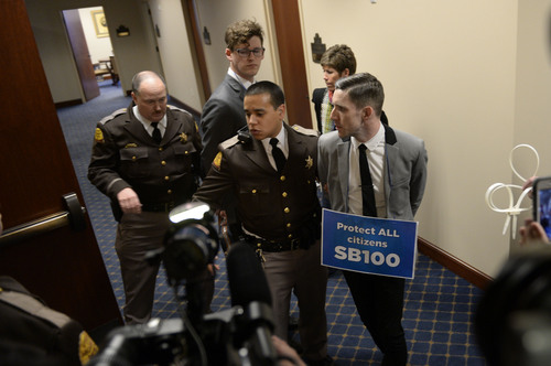 Francisco Kjolseth  |  The Salt Lake Tribune
LGBT activists are arrested after blocking the doors to Senate committee room 210 at the Utah state Capitol on Monday, Feb. 9, 2014, in an effort to bring attention to anti-discrimination bill SB 100 with hopes of a hearing.