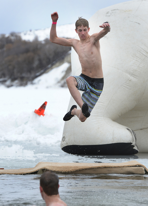Scott Sommerdorf   |  The Salt Lake Tribune
Tanner Zilles jumps into the frigid waters on Hyrum Reservoir after his friend Briant Christensen. They made the jump five time. Participants in the Polar Plunge raised funds for Utah Special Olympics by jumping into the Hyrum reservoir, in Hyrum, Saturday, Feb. 8, 2014.