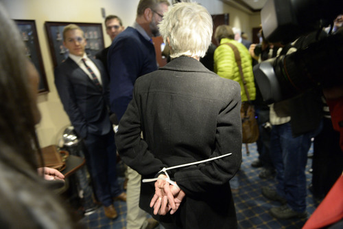 Francisco Kjolseth  |  The Salt Lake Tribune
Gail Murdock is arrested along with other LGBT activists after blocking the doors to Senate committee room 210 at the Utah state Capitol on Monday, Feb. 9, 2014, in an effort to bring attention to anti-discrimination bill SB 100 with hopes of a hearing.