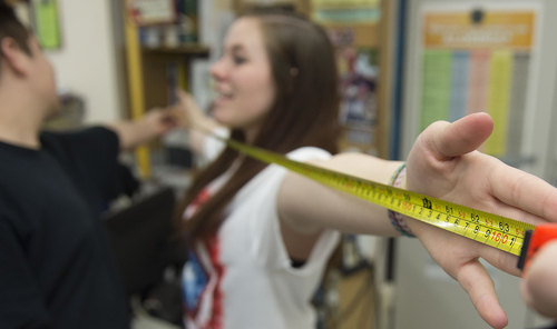 Keith Johnson | The Salt Lake Tribune

Isaac Rodrigo Munoz measures Crystal Williams' armspan in Rob Lake's introduction to statistics class at Kearns High School, February 5, 2014 in Kearns, Utah. Each student has a Texas Instruments wireless calculator that transmits its data onto a screen for all to see. The Utah Legislature is looking into infusing millions of dollars for technology in Utah classrooms. Kearns High received a $1 million grant 3 years ago, allowing every student to get an iPod touch to help in the classroom. The results were mixed.