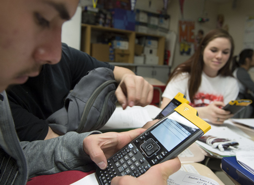 Keith Johnson | The Salt Lake Tribune

Jonathon Meza, left, and Crystal Williams use their Texas Instruments wireless calculators in Rob Lake's introduction to statistics class at Kearns High School, February 5, 2014 in Kearns, Utah. Each student has a calculator that transmits its data onto a screen for all to see. The Utah Legislature is looking into infusing millions of dollars for technology in Utah classrooms. Kearns High received a $1 million grant 3 years ago, allowing every student to get an iPod touch to help in the classroom. The results were mixed.