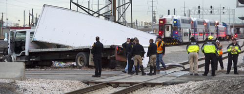 Steve Griffin  |  The Salt Lake Tribune
A FrontRunner train is stopped on the tracks after colliding with a truck at an intersection at 1800 N. and Warm Springs Road in Salt Lake City on  Wednesday.