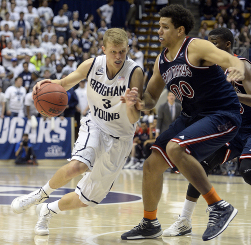 Rick Egan  | The Salt Lake Tribune 

Brigham Young Cougars guard Tyler Haws (3) drives up the middle, as Brad Waldow (00) defends, in basketball action, BYU vs. St Mary's, at the Marriott Center, Saturday, February 1, 2014.