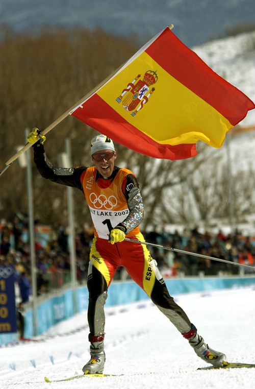 Paul Fraughton  |  Tribune file photo

Johann Muehlegg of Spain crosses the finish line of the Men's 10K Free Pursuit waving his country's flag.