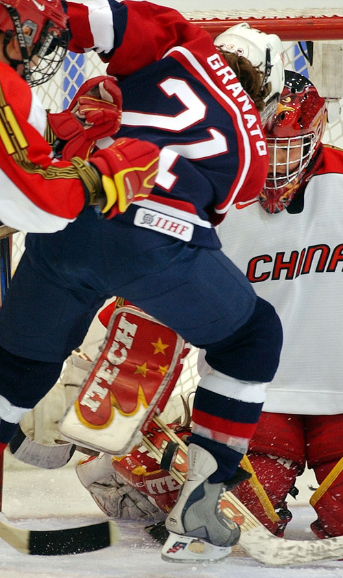 |  Tribune file photo
USA's Cammi Granato takes a shot on goal as China's Hong Guo blocks the shot as the teams face each other in the 2002 Winter Olympic Games. USA won the game 12-1.