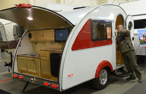 Leah Hogsten  |  The Salt Lake Tribune
Dave Winegar of Park City videos the inside of he "teardrop" trailer with outdoor kitchen for $17,400. The Utah Sportsmen's, Vacation & RV Show has plenty of eye-catching interests including RV's, trucks, ATV's, outdoor recreation equipment, RV accessories and dog agility demonstrations, cooking demos, a fly tie theater and Dutch oven cooking demos, Thursday, February 13-16, 2014  at the South Towne Expo Center.