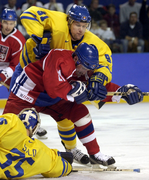 Ryan Galbraith  |  Tribune file photo

Sweden's Markus Naslund holds Czech Republic's Robert Reichel as Sweden's goalkeeper Tommy Salo makes a save during the 2002 Winter Olympics.