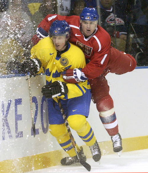 Ryan Galbraith | Tribune file photo
Czech Republic's Jaroslav Spacek crashes into Sweden's Jorgen Jonsson during the 2002 Winter Olympics.