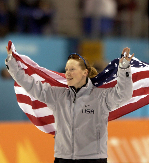 Steve Griffin | Tribune file photo
Draped in the American Flag, Chris Witty of the United States skates a victory lap around the Utah Olympic Oval after setting a world record and winning the gold medal in the women's 1000 meters during the 2002 Winter Olympics.