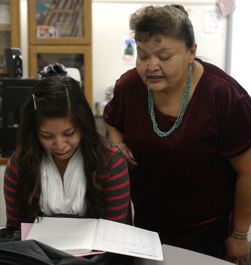 Rick Egan  |  The Salt Lake Tribune
Caitlyn Black, left, reads a story she wrote in the Navajo language to her teacher, Dorothy Bigman, during class time at Monument Valley High School in January.