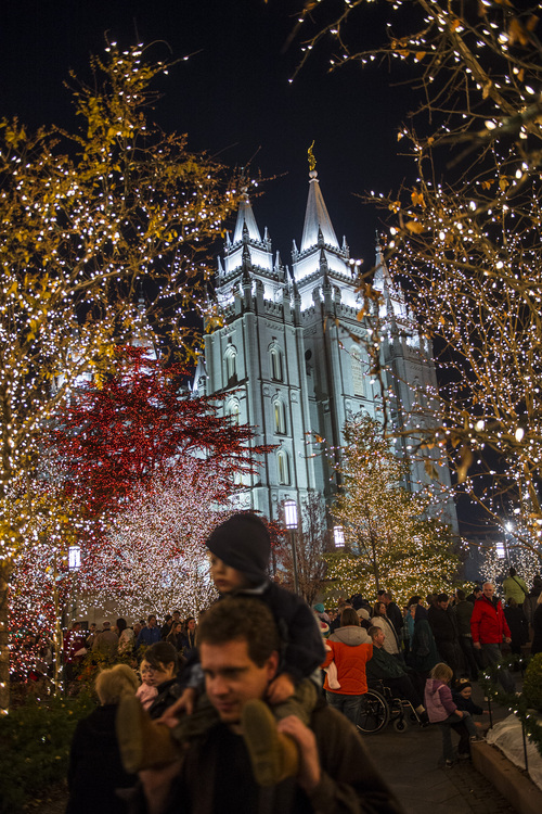 Chris Detrick  |  The Salt Lake Tribune
Visitors look at the Christmas lights on Temple Square Friday November 29, 2013.  The first year the light were put up on Temple Square was in 1965. The lights will run through the end of the year.