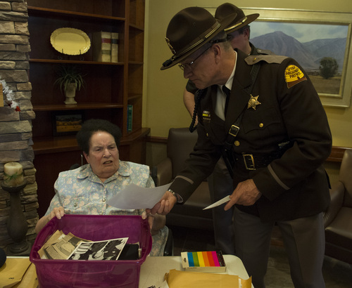 Rick Egan  | The Salt Lake Tribune 

Kathleen Warren looks through a box of photos along with Les Langford of the Utah Highway Patrol.  The box was recently found in a house in Payson. Sunday, February 16, 2014. Chuck Warren was shot while on duty for the Utah Highway Patrol in 1969.