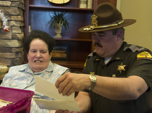 Rick Egan  | The Salt Lake Tribune 

Kathleen Warren looks through a box of photos along with Lee Perry of the Utah Highway Patrol.  The box was recently found in a house in Payson. Sunday, February 16, 2014. Chuck Warren was shot while on duty for the Utah Highway Patrol in 1969.