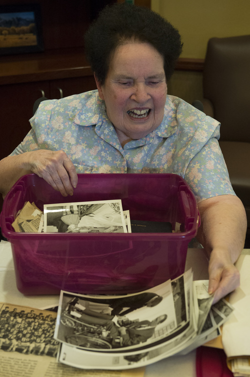 Rick Egan  | The Salt Lake Tribune 

Kathleen Warren looks through a box of photos recently found in a house in Payson  containing old photos and news clippings of her late husband, Chuck Warren, at a care center in Payson, Sunday, February 16, 2014. Chuck Warren was shot while on duty for the Utah Highway Patrol in 1969.