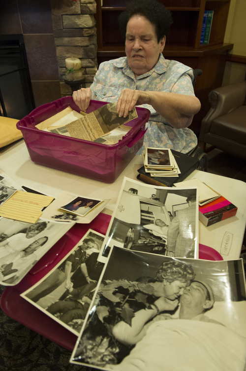 Rick Egan  | The Salt Lake Tribune 

Kathleen Warren looks through a box of photos recently found in a house in Payson  containing old photos and news clippings of her late husband, Chuck Warren, at a care center in Payson, Sunday, February 16, 2014. Chuck Warren was shot while on duty for the Utah Highway Patrol in 1969.