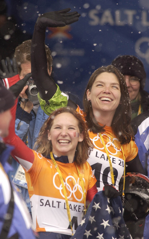 Francisco Kjolseth | Tribune file photo
Tristan Gale, foreground, and Lea Ann Parsely of the United States, acknowledge the fans after taking gold and silver respectively in women's skeleton during the 2002 Winter Olympics.