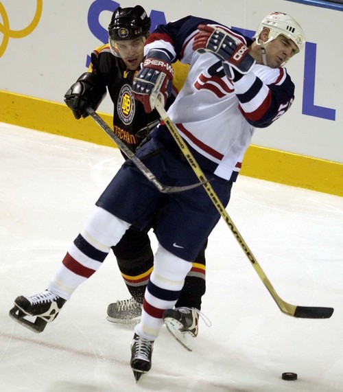 Trent Nelson | Tribune file photo 
Germany's Daniel Kunce was penalized for high sticking after mashing USA's John Leclair in the 2nd Period during the 2002 Winter Olympics.