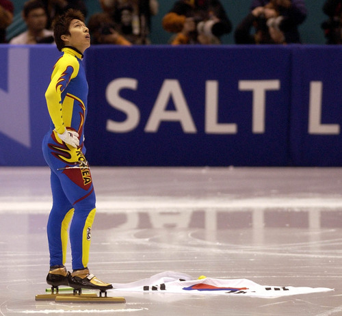 Steve Griffin | Tribune file photo
With the Korean flag on the ice, Korea's Kim Dong-sung looks up at the scoreboard after learning that he had been disqualified in the finals of the men's short track 1500 meters costing him the gold medal during the 2002 Winter Olympics.
