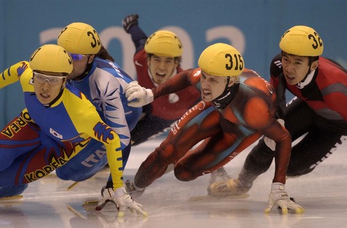 Trent Nelson | Tribune file photo
(l to r) USA's Apolo Anton Ohno lags in the back of the pack lead by Korea's Kim Dong-Sung in the men's 1500m final during the 2002 Winter Olympics.