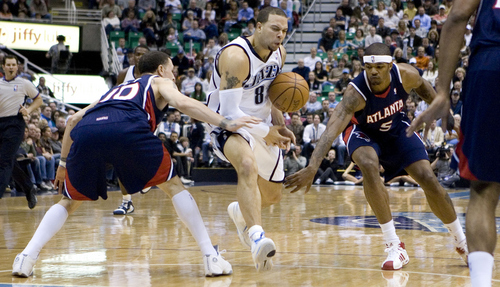 Utah's Deron Williams (8) is fouled by Atlanta's Mike Bibby (10) as Josh Smith (5) applies defensive pressure as the Jazz face the Hawks at EnergySolutions Arena Saturday February 23, 2008. 

Jeremy Harmon/The Salt Lake Tribune