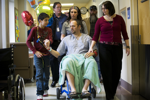 Deputy Greg Sherwood, center, is joined by his wife Gina Sherwood, right, son Braxton, left, and other family and friends as he is moved from his hospital room to a recovery ward at Utah Valley Regional Medical Center in Provo Monday, Feb. 10, 2014. 

MARK JOHNSTON/Daily Herald