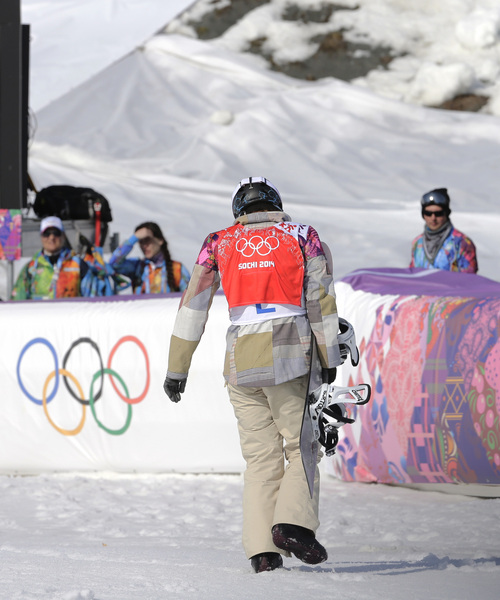 Lindsey Jacobellis  of the United States walks off after crashing in the second semifinal of the women's snowboard cross at the Rosa Khutor Extreme Park, at the 2014 Winter Olympics, Sunday, Feb. 16, 2014, in Krasnaya Polyana, Russia. (AP Photo/Andy Wong)