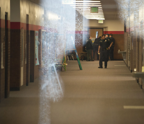 Lennie Mahler  |  The Salt Lake Tribune
Police search the halls of Sandy Elementary School for a burglary suspect as the school was on lockdown Wednesday, Feb. 19, 2014. Multiple parents had heard word of a bomb threat, which police did not confirm.