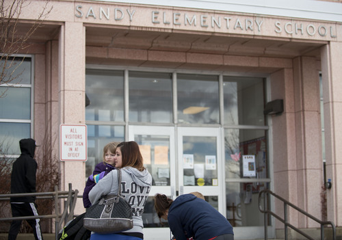 Lennie Mahler  |  The Salt Lake Tribune
Parents leave Sandy Elementary School with their children after the school went on lockdown as police searched for a burglary suspect Wednesday, Feb. 19, 2014. Multiple parents had heard word of a bomb threat, which police did not confirm.