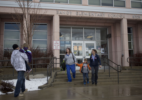 Lennie Mahler  |  The Salt Lake Tribune
Parents leave Sandy Elementary School with their children after the school went on lockdown as police searched for a burglary suspect Wednesday, Feb. 19, 2014. Multiple parents had heard word of a bomb threat, which police did not confirm.
