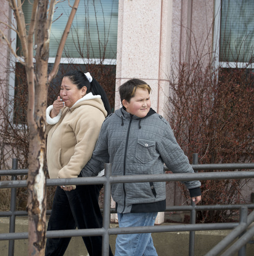 Lennie Mahler  |  The Salt Lake Tribune
Brenda Larner leaves Sandy Elementary School with her son, Jasmine, after the school went on lockdown as police searched for a burglary suspect Wednesday, Feb. 19, 2014. Multiple parents had heard word of a bomb threat, which police did not confirm.