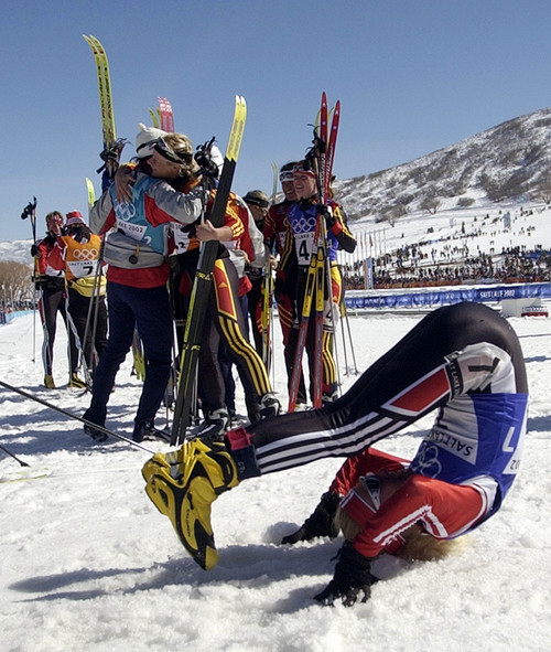 |  Tribune file photo

While Germany celebrates their gold medal race in the background, Natascia Leonardi Cortesi of Switzerland rolls around on the snow after crossing the finish line to capture the bronze medal for her team following the Women's 4 by 5 km Relay at Soldier Hollow on Thursday, Feb. 21, 2002.  Germany captured the gold by a narrow margin over Norway while Switzerland took the bronze.