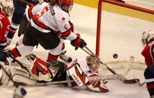 Danny La  |  Tribune file photo

Canada's Goalie #33 Kim St. Pierre (bottom) blocks a shot attempt by the USA's #25 Tricia Dunn (right) at the E Center in West Valley City.