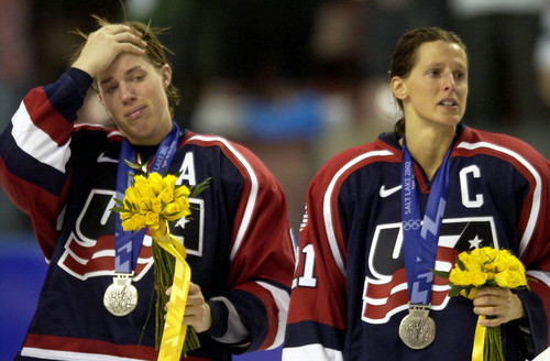 Steve Griffin  |  Tribune file photo
With silver medals around their necks Karyn Bye (left) and Cammi Granato cry as the Canadians except their gold medals at the E Center Feb. 21, 2002.