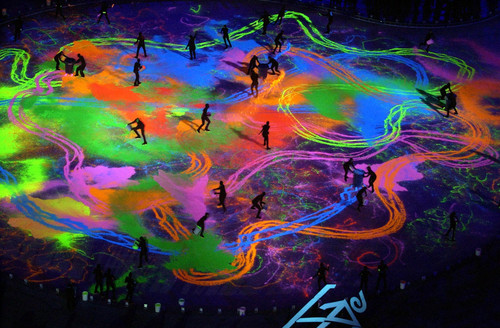 Paul Fraughton  |  Tribune file photo

The stadium ice is covered with colored sand in a spectacular black light section of the Closing Ceremony.