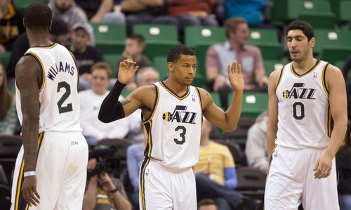 Lennie Mahler  |  The Salt Lake Tribune
Jazz guard Trey Burke denies a foul call, with teammates Marvin Williams, left, and Enes Kanter, right, in the first half of a game Saturday, Feb. 22, 2014, in Salt Lake City.