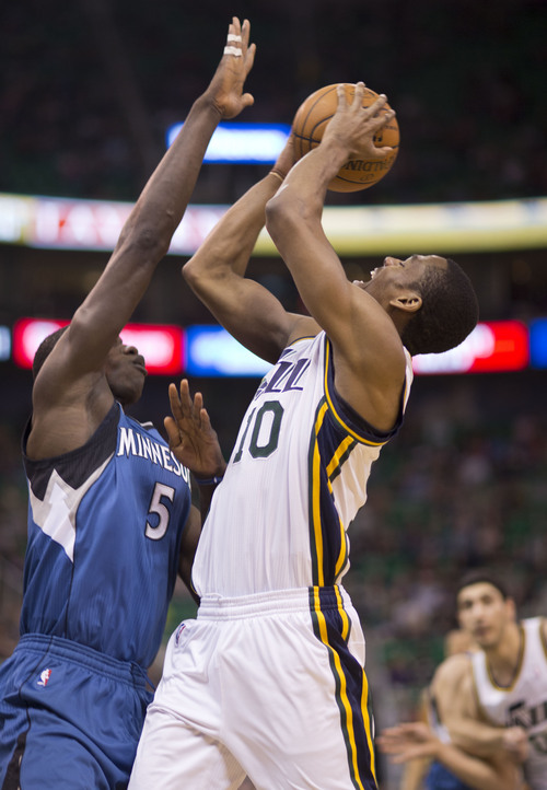 Lennie Mahler  |  The Salt Lake Tribune
Utah Jazz guard Alec Burks is fouled on his way to the basket by Timberwolves Center Gorgui Dieng in the first half of a game Saturday, Feb. 22, 2014, in Salt Lake City.