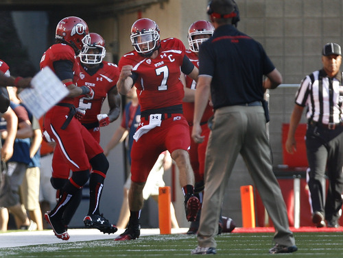 Scott Sommerdorf   |  The Salt Lake Tribune
Utah QB Travis Wilson celebrates with WR Dres Anderson after they connected on a 3yd TD pass to give Utah a quick 7-0 lead over USU early in the 1st period, Thursday, August 29, 2013.