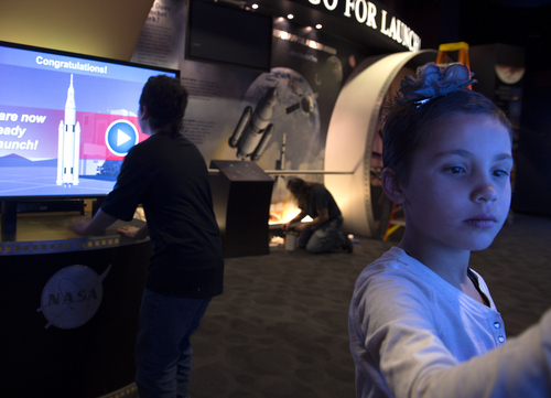 Keith Johnson | The Salt Lake Tribune

Alivia Castro (7), right, and Benito Archuleta (12) play with an interactive display at the new space exploration exhibit at Clark Planetarium, February 25, 2014 in Salt Lake City.