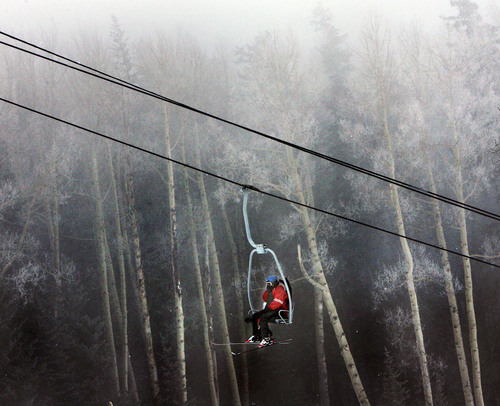 Steve Griffin  |  The Salt Lake Tribune
A skier rides the Skyline Double Chair ski lift as fog and snow blanket the mountain top during opening day at Eagle Point ski resort above Beaver, Utah Wednesday, December 15, 2010.