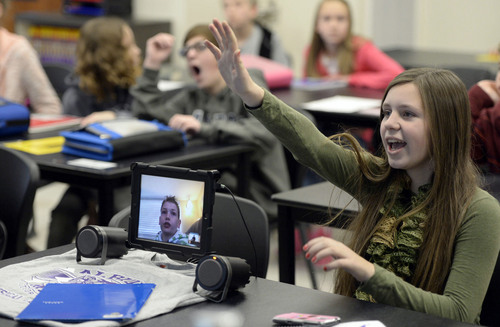 Francisco Kjolseth  |  The Salt Lake Tribune
Meghan Hawkesworth, 12, answers a science question in class while sitting next to classmate, Andrew Gardner on screen. Gardner nearly drowned as a child, permanently damaging his lungs. To avoid Utah'spollution-trapping inversions he spends much of the winter ine Arizona with his grandparents.