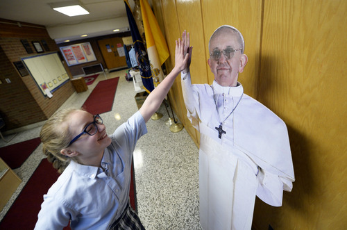 Francisco Kjolseth  |  The Salt Lake Tribune
Emily Malouf, 11, gives a life-size cardboard cutout of Pope Francis a high-five as it greets students arriving at St. Vincent de Paul Catholic School on Thursday morning, Feb. 20, 2014. This "Pope Francis" gets moved around a bit but can typically be found near the school office.