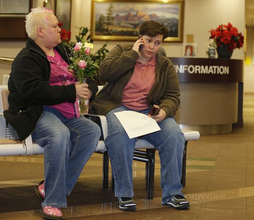 Patsy Carter left, and Raylynn Marvel  right, from Orem, Utah, talk on the phone outside the offices of the Utah County Clerk and Auditor office and hold a rejection letter for a marriage license on Dec. 20, 2013 in Provo, Utah. A federal judge on Friday struck down Utah's ban on same sex marriage saying the law violates the U.S. Constitution.  (Photo by George Frey  |  Special to the Tribune)