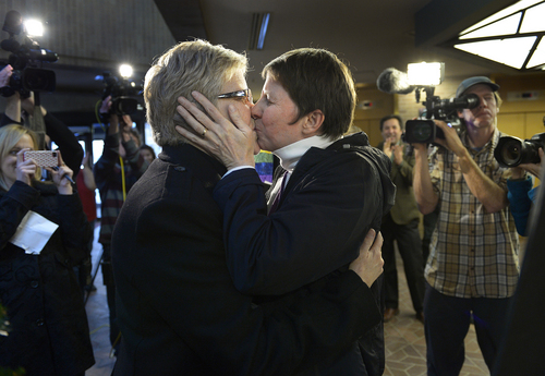 Scott Sommerdorf   |  The Salt Lake Tribune
Laurie Wood, left, and Kody Partridge, kiss after being told that they are officially married by the Rev. Curtis L. Price in the lobby of the Salt Lake County offices, Friday December 20, 2013.